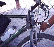 Bicycle equipped with hooks to support long, slender freight such as pipes.
